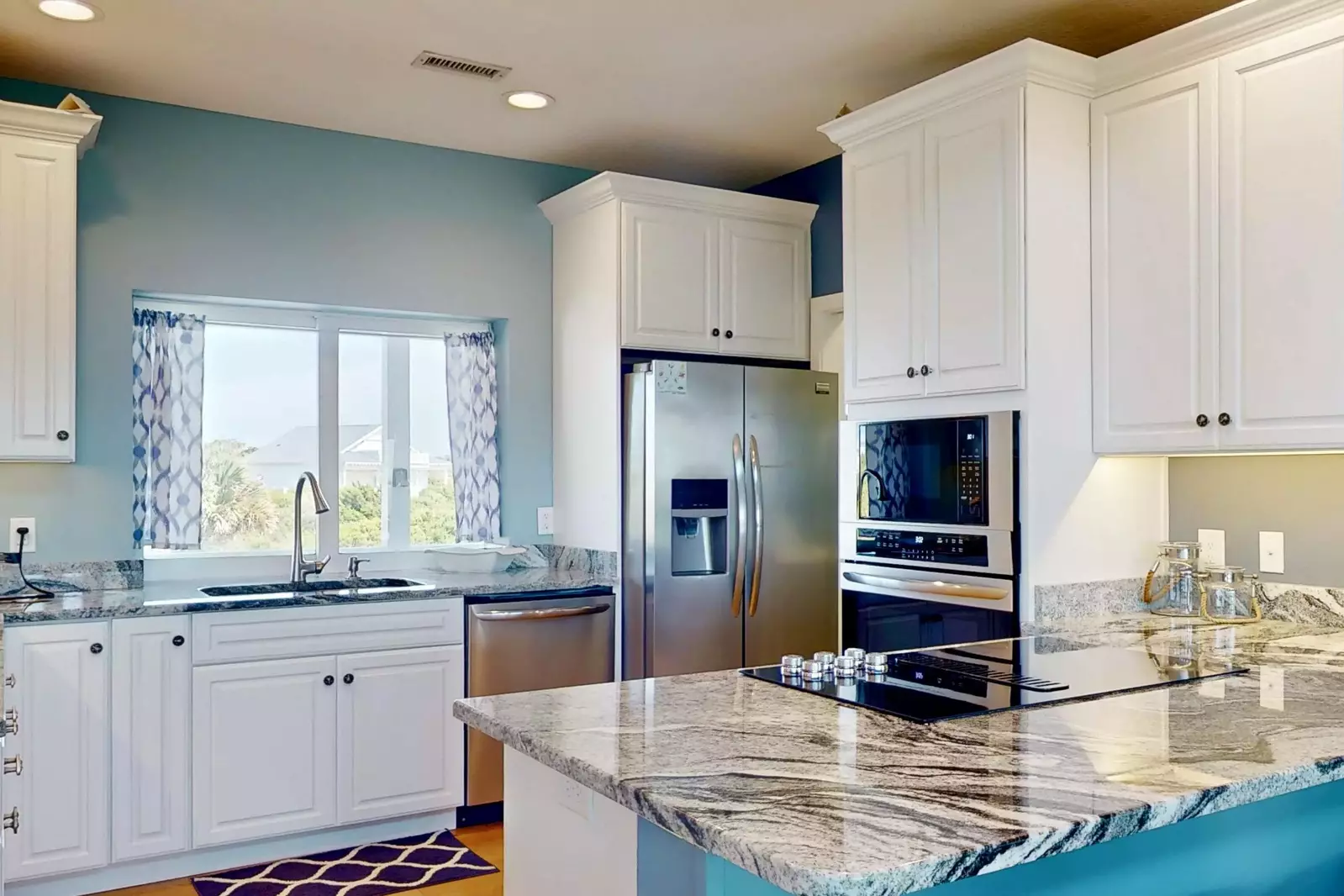 The kitchen features stainless steel appliances and everything you need to make a great meal