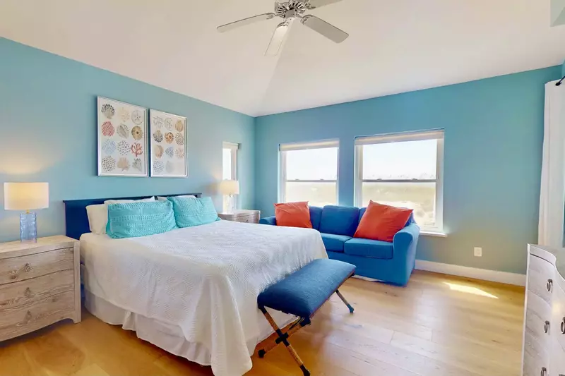 The primary suite has a private seating area and door to the porch