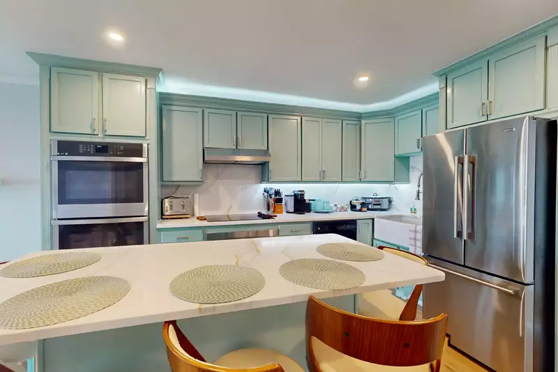 Stainless steel appliances and coastal colors equal a beautiful kitchen