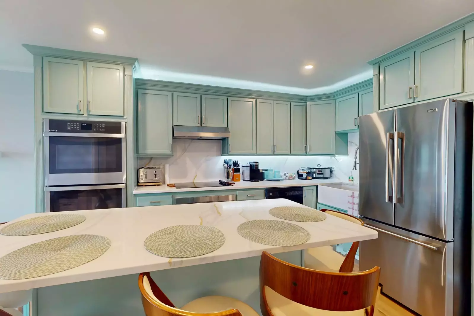 Stainless steel appliances and coastal colors equal a beautiful kitchen