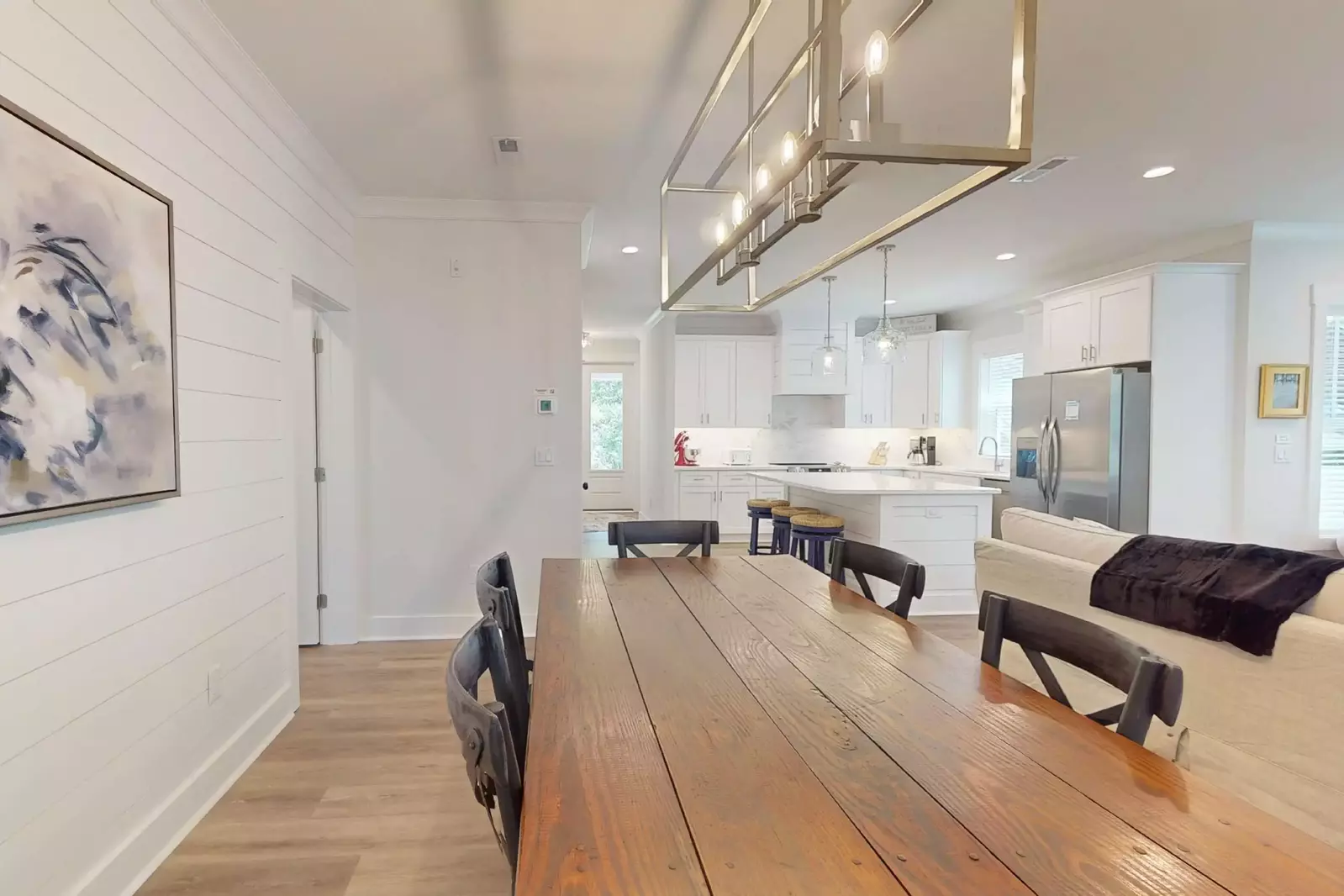 The dining table seats 6 with extra seating at the kitchen island