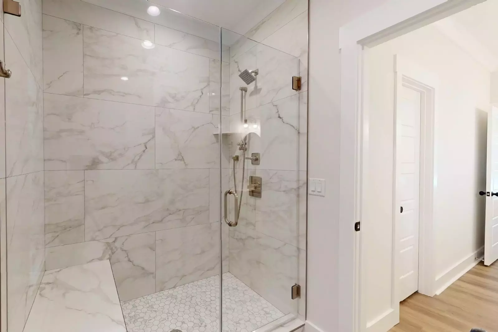 Owner's suite walk in shower with bench