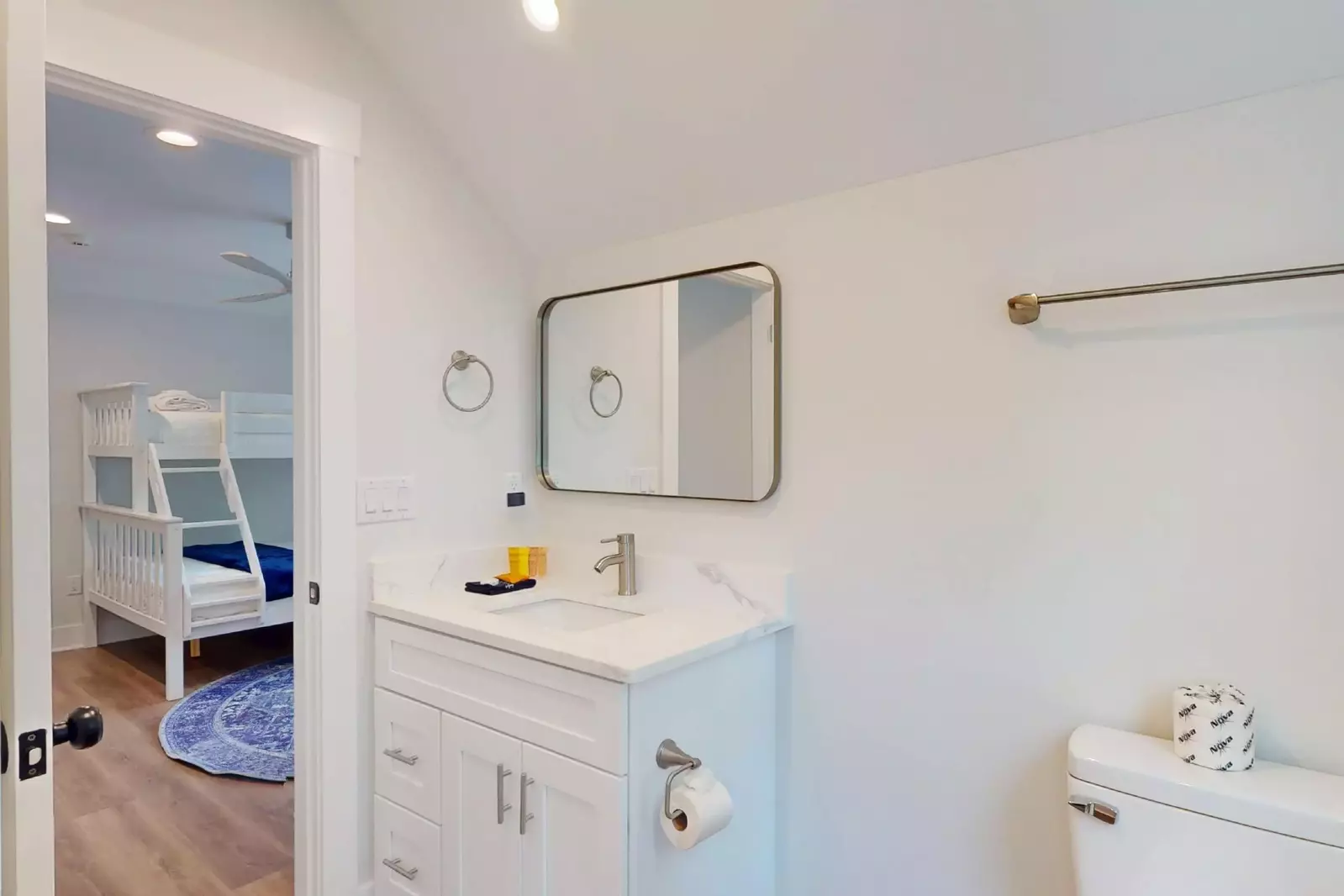 Sink and toilet portion of the upstairs full bathroom