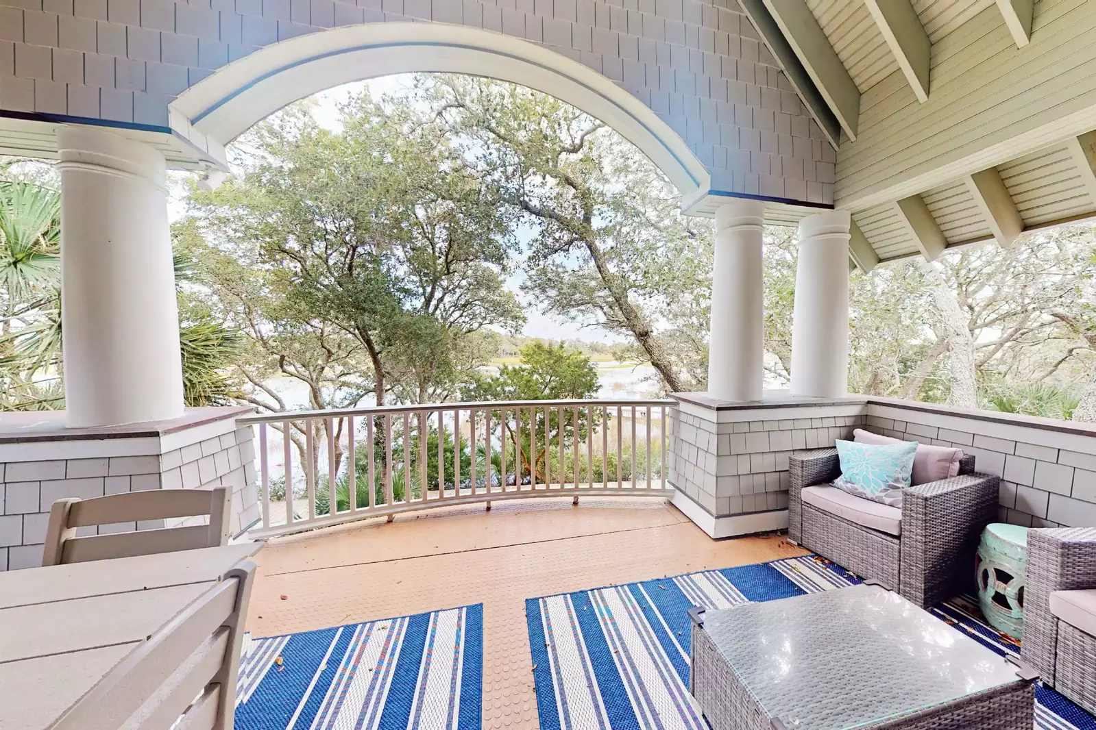 The upstairs covered deck offers plenty of seating and views of the marsh