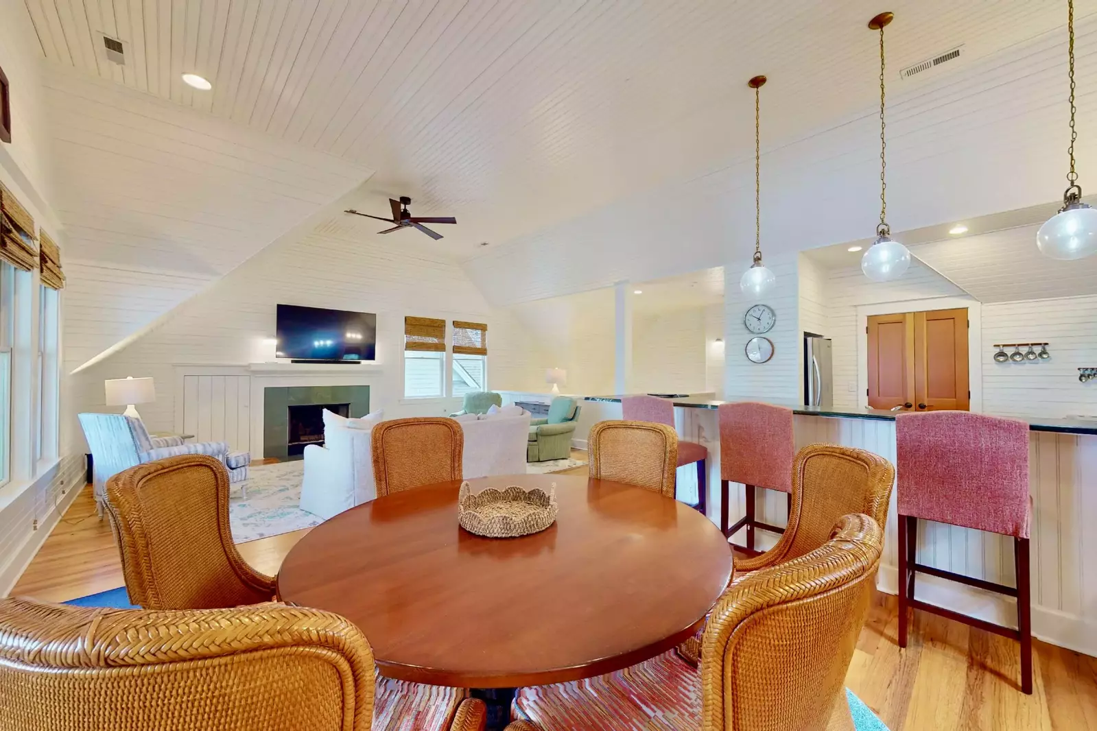 The dining room table seats 6 with additional seating at the bar counter