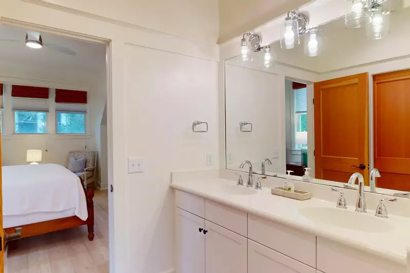 The upstairs ensuite has double sinks and a walk-in shower with a built in bench