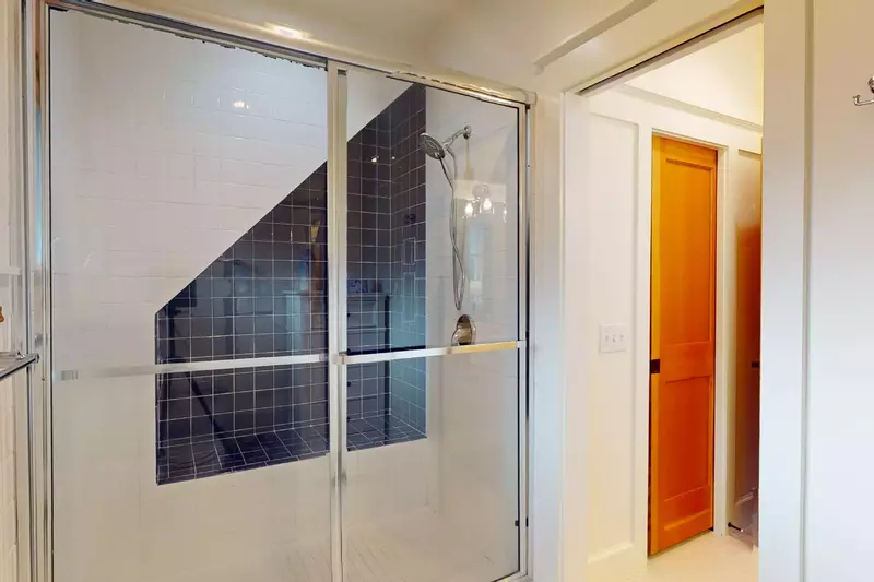 The upstairs ensuite has a walk-in shower with built-in bench