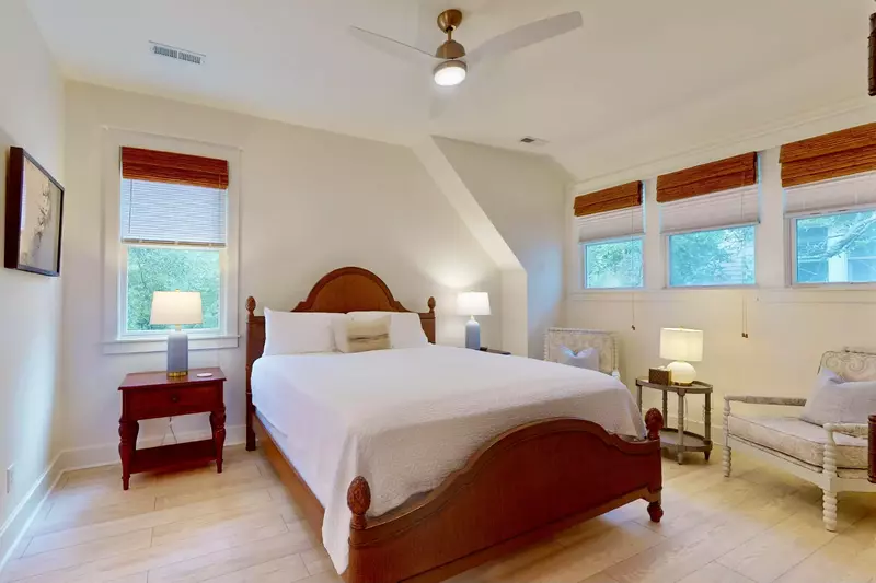 The upstairs king bedroom offers plenty of natural light, a sitting area and an ensuite with a walk-in shower.