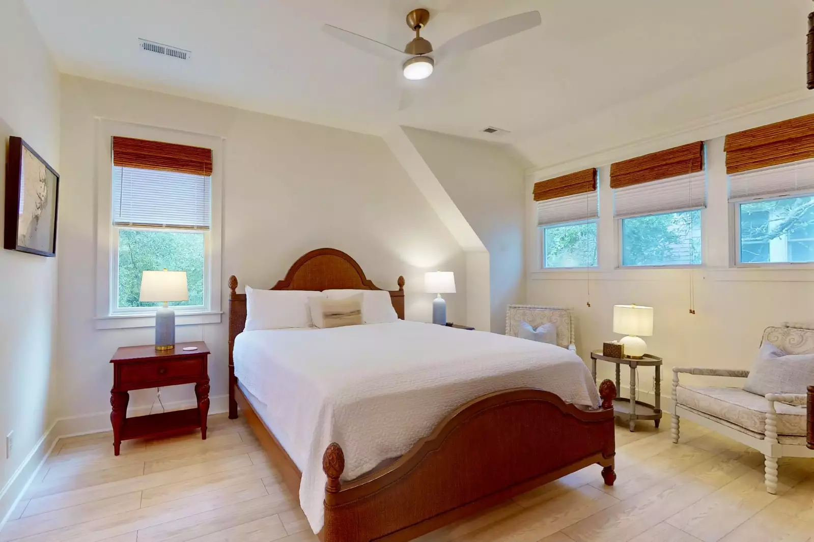 The upstairs king bedroom offers plenty of natural light, a sitting area and an ensuite with a walk-in shower.