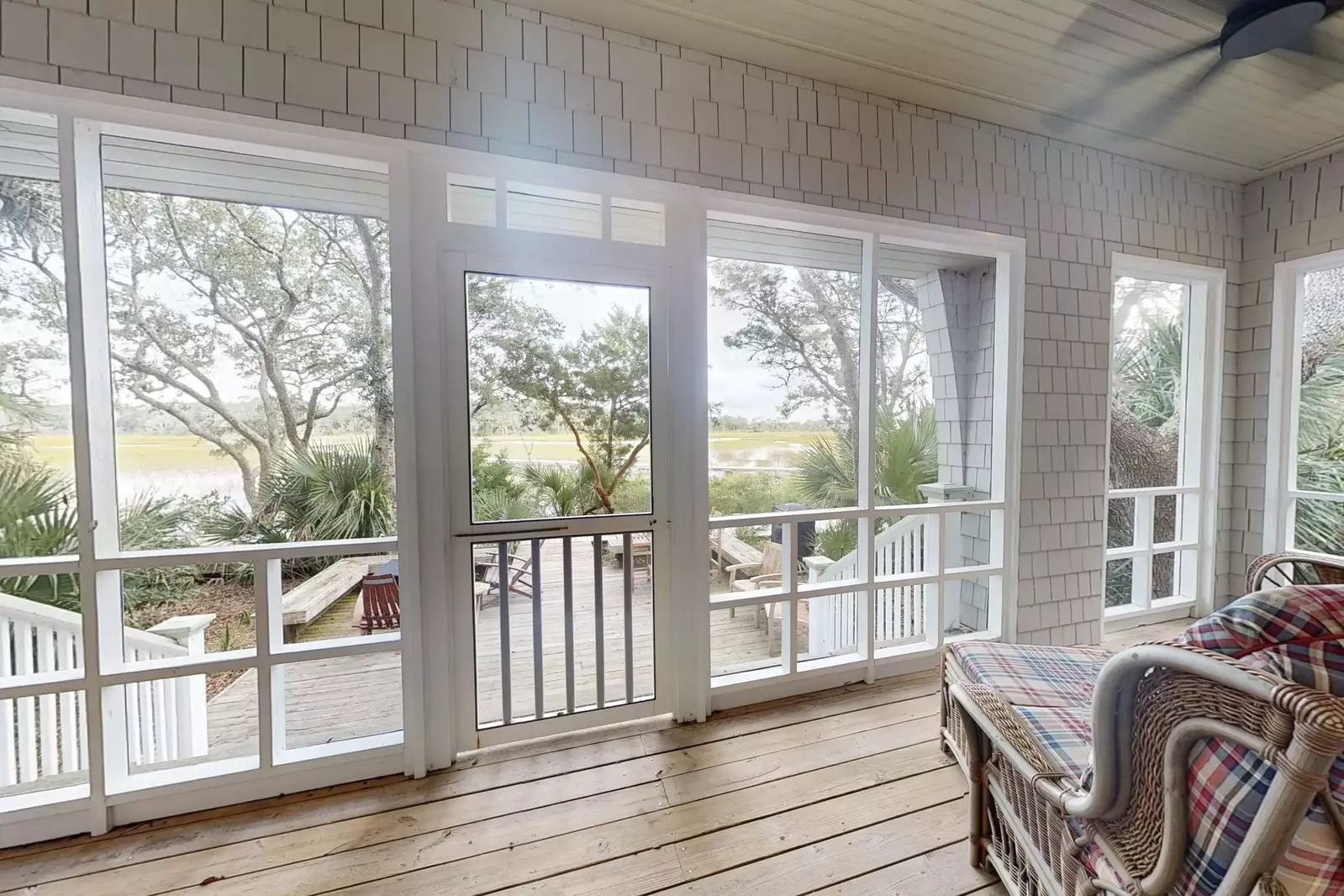 The screened patio offers stunning views of the water