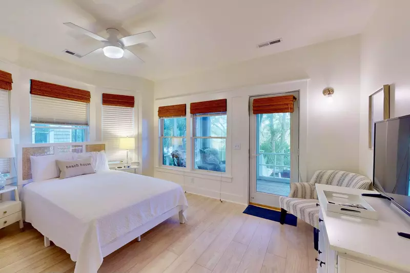 The downstairs queen bedroom also features direct access to the screened patio and marsh views