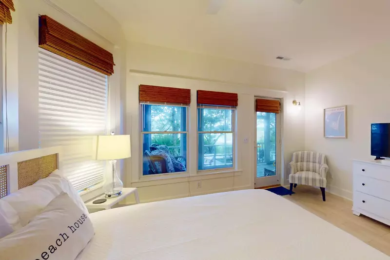 This bedroom features windows overlooking the water