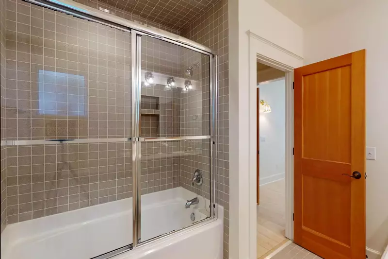This ensuite features a tub shower combo and is attached to the twin room
