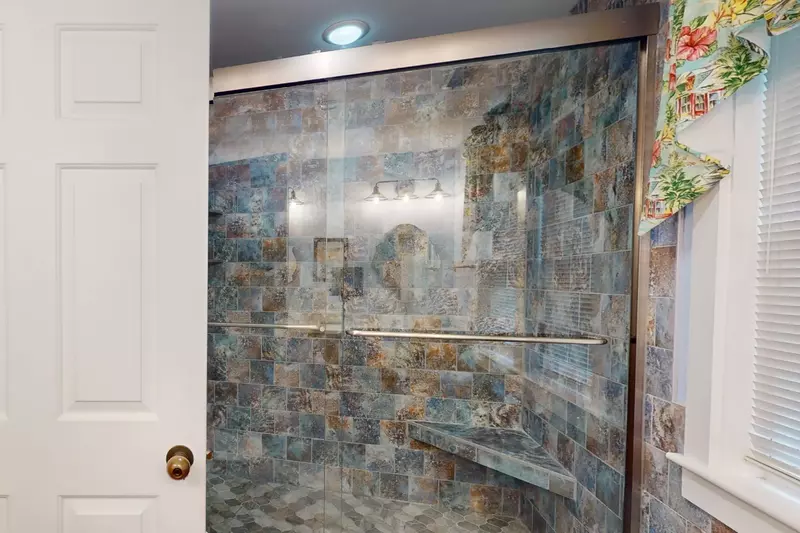 The master ensuite features a walk-in shower with seat