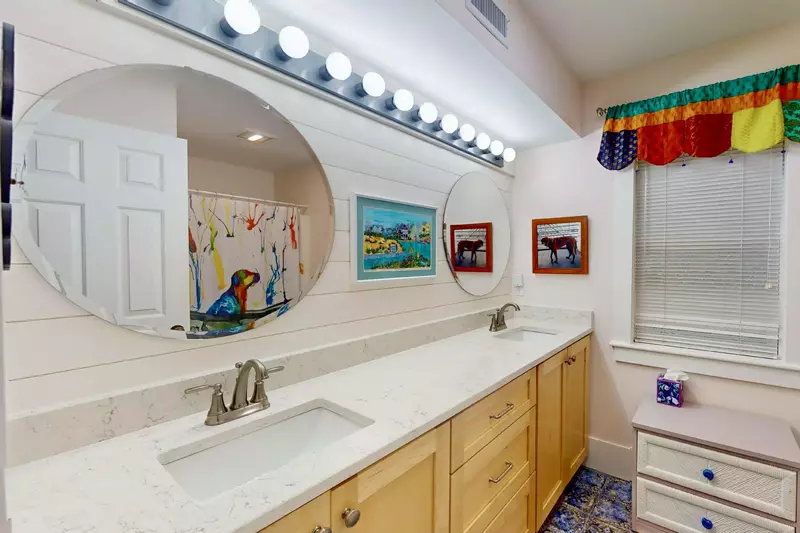The bunk room ensuite is functional and fun with double sinks, a long counter and pops of color