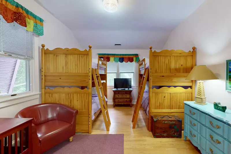 The bunk room also has a sitting area and floor space to play