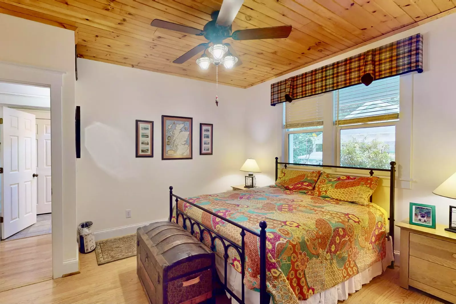 The downstairs queen bedroom has a wood ceiling and a full bathroom across the hall