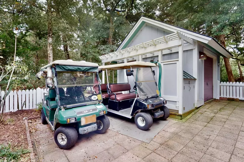 This home includes two golf carts - one 6 seater and one 4 seater - including one with enclosure panels for cold/rainy days