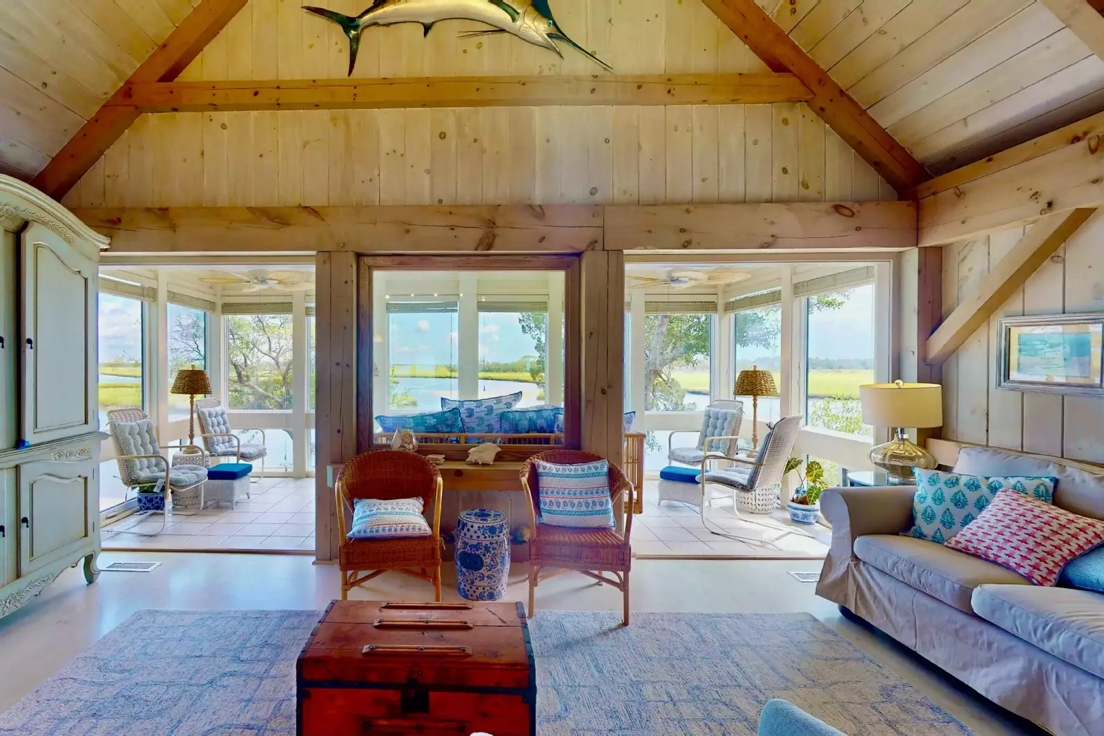 The four seasons room lets in tons of natural light and has two double doorways connecting it to the living room