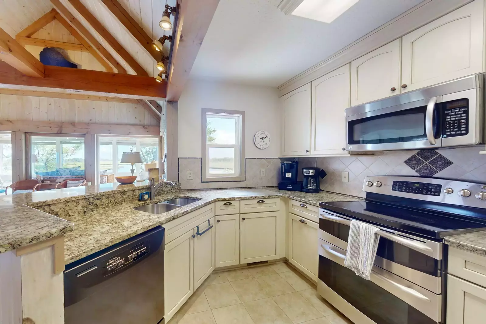 The kitchen features stainless steel appliances and everything you need to make a great meal