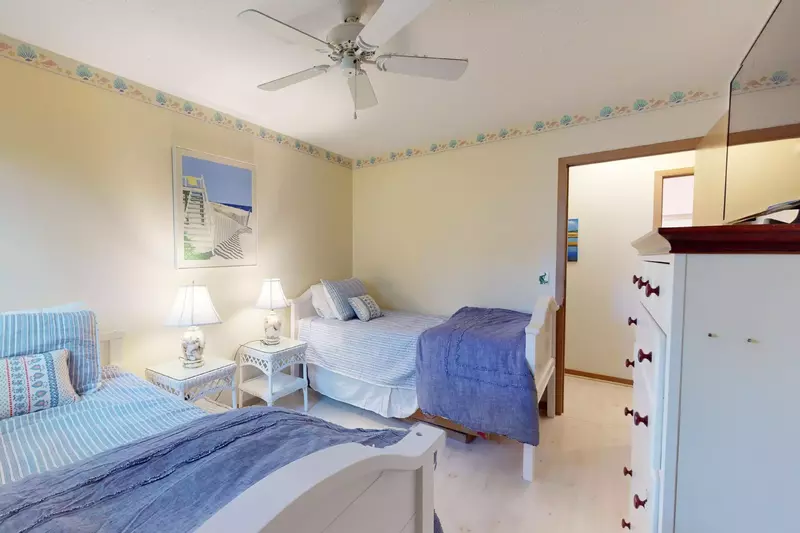 The 3rd bedroom has two twin beds and a beachy theme