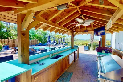 Outdoor kitchen with grill, tv and mini fridge
