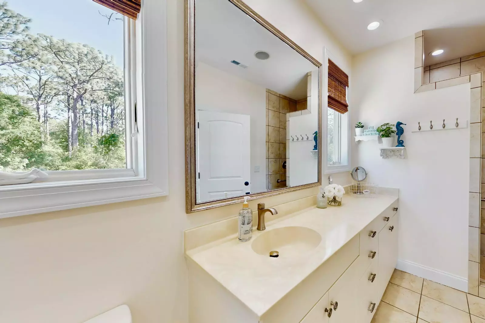 The full bathroom provides natural light and loads of counter space