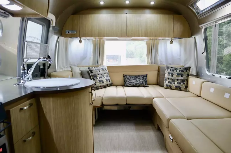 Relax in the comfortable seating area inside the Airstream add on