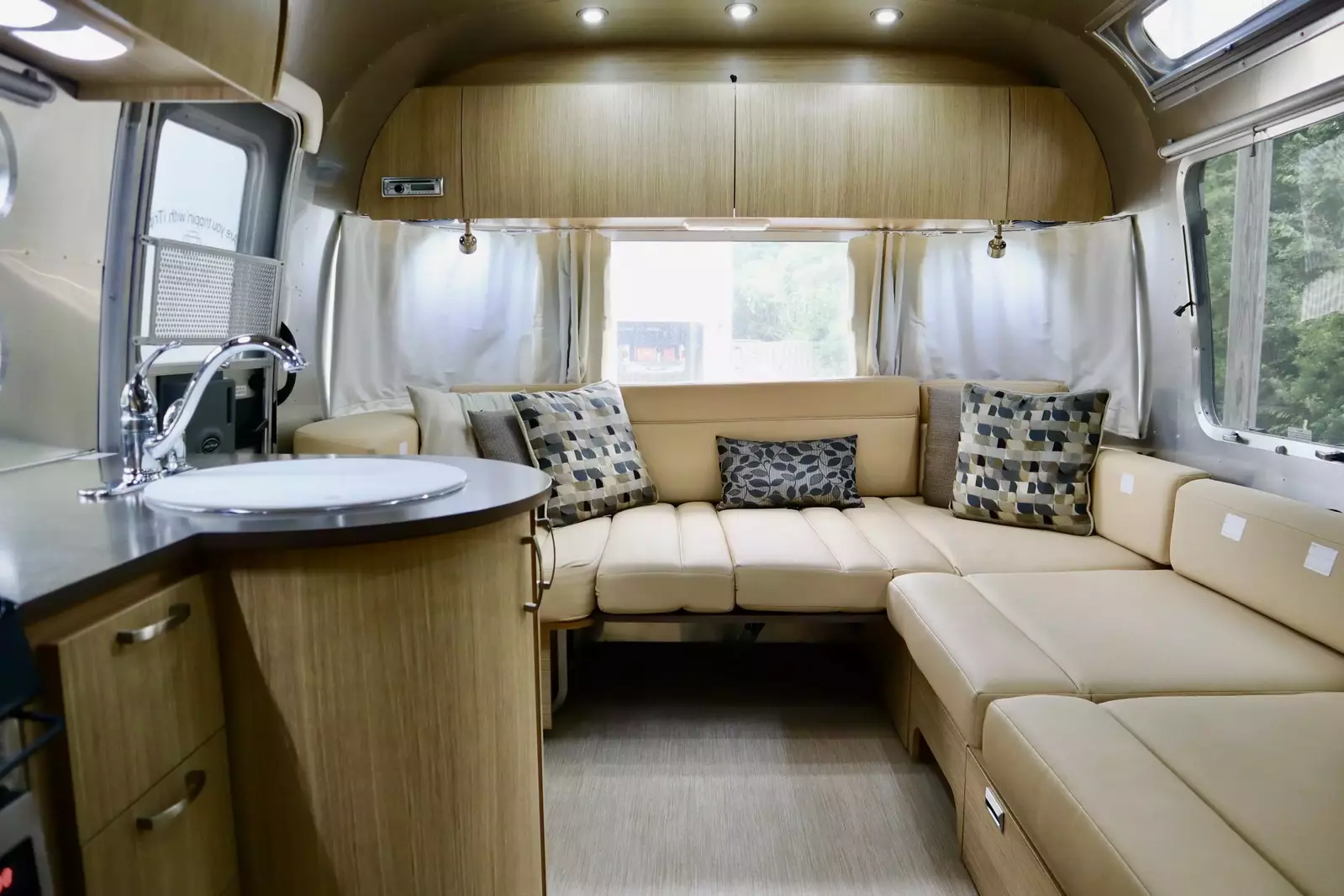 Relax in the comfortable seating area inside the Airstream add on