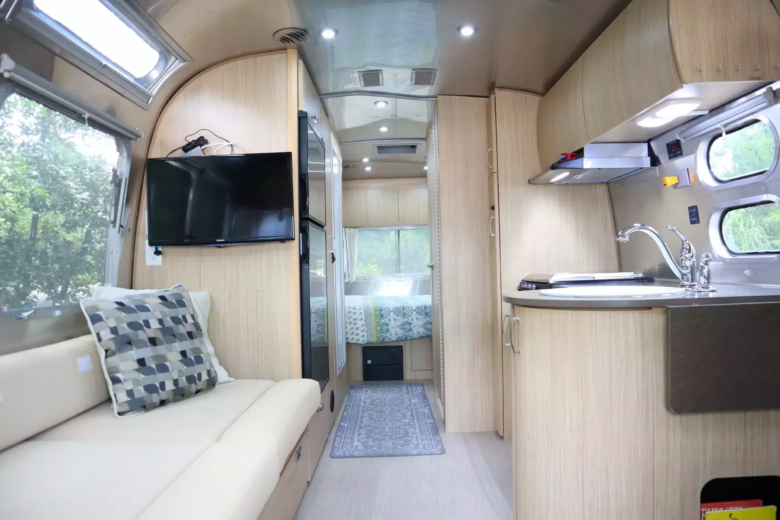 The Airstream add on has full electrical, a flat screen tv, a small fridge and running water