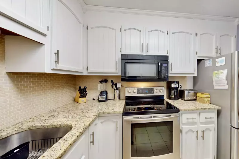 Kitchen features stainless steel appliances, new countertops and backsplash