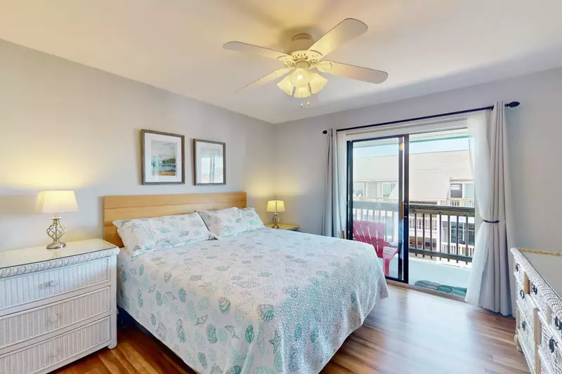 Second bedroom features a king bed and access to the rear balcony