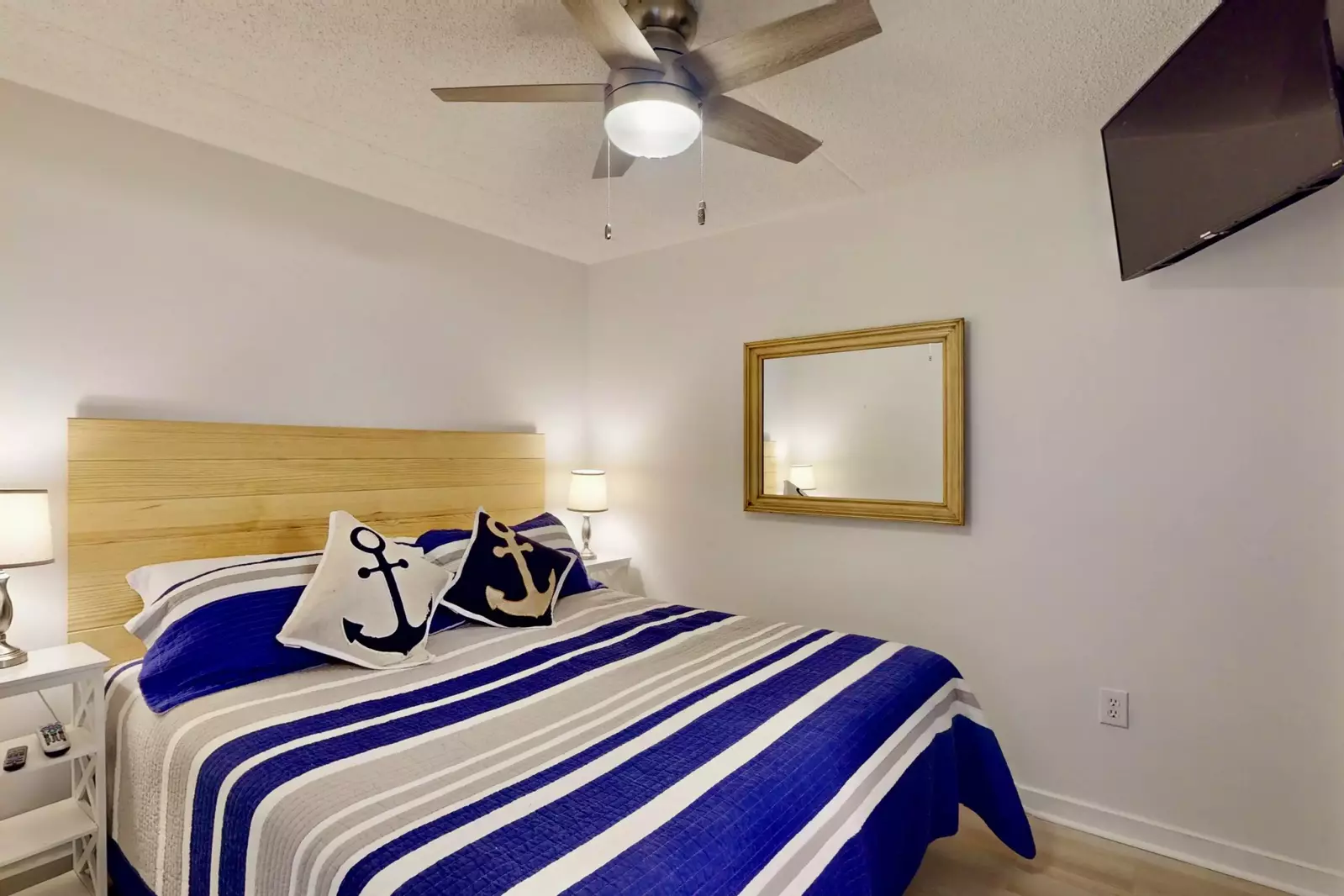 The master features a king bed and wall mounted tv