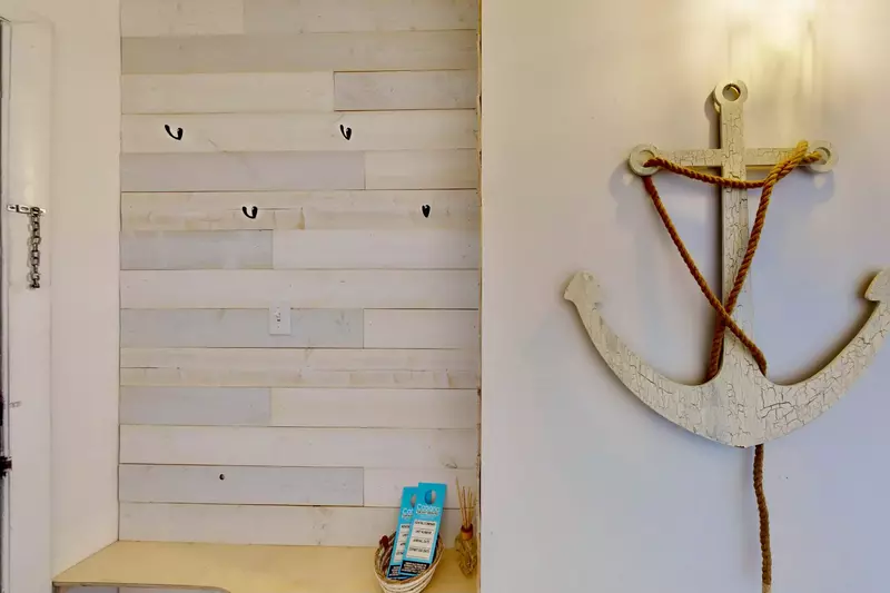 Custom wood wall provides a warm entry to this lovely condo