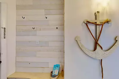 Custom wood wall provides a warm entry to this lovely condo