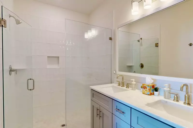 Master suite has a double sink vanity and tiled walk in shower