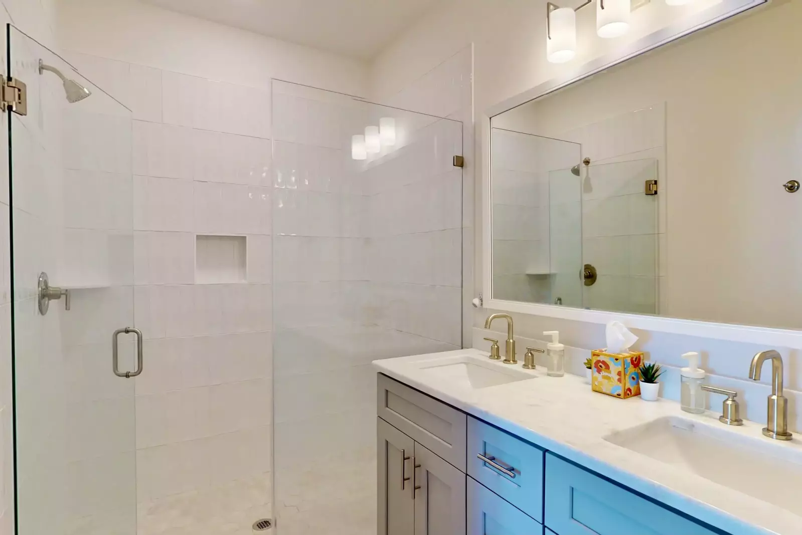 Master suite has a double sink vanity and tiled walk in shower
