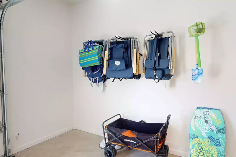 Beach wagon, chairs and toys can be found in the garage