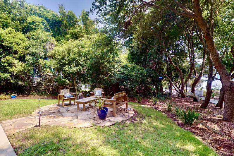 The outdoor area is wonderful to relax at, surrounded by trees for seclusion