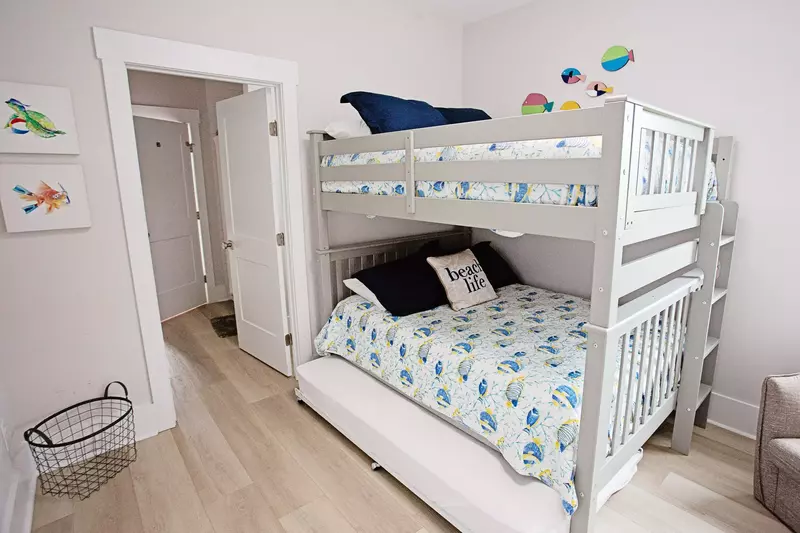 The bunk room features a full over full bunkbed with a twin rollaway underneath and a jack and jill bathroom