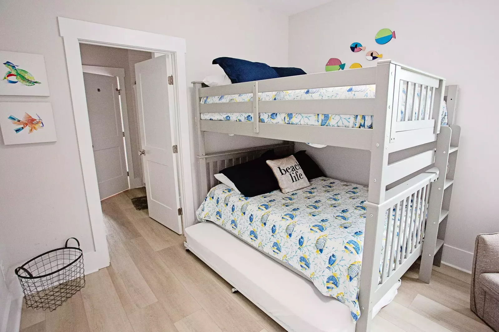 The bunk room features a full over full bunkbed with a twin rollaway underneath and a jack and jill bathroom