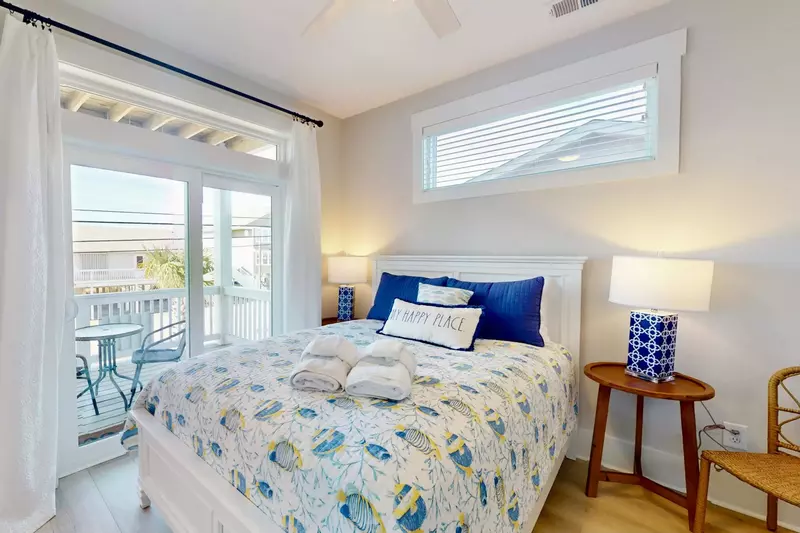 The queen bedroom has a private balcony and shares a jack and jill bathroom with the bunk bedroom