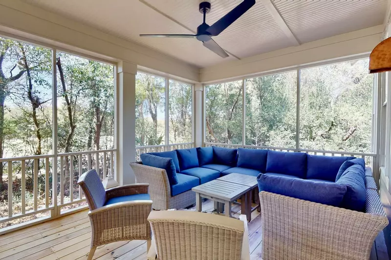 The back deck features a huge U-shaped couch and 2 comfy chairs