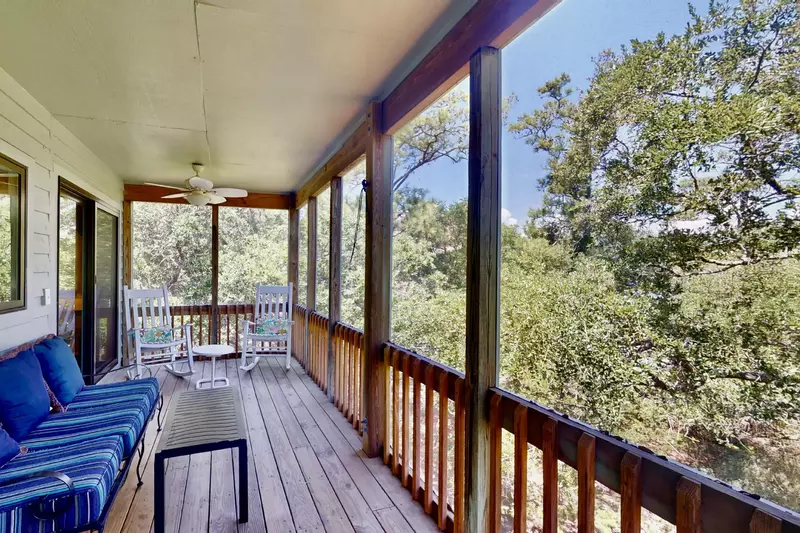 Enjoy the sights and sounds of nature on this screened in porch