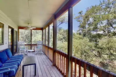 Enjoy the sights and sounds of nature on this screened in porch