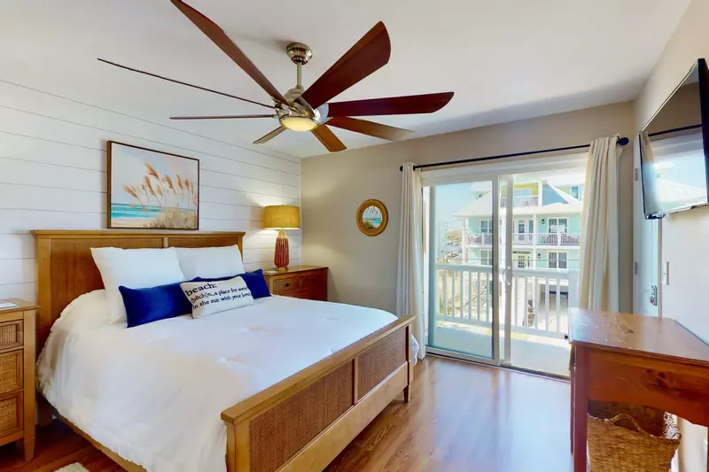The owner's suite boasts a shiplap wall, queen bed, wall mounted tv and ensuite