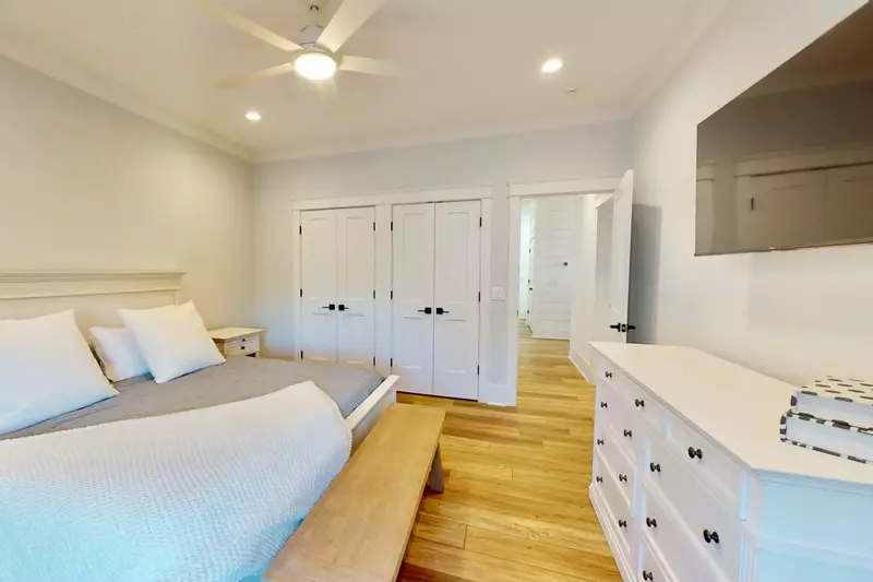 This bedroom has plenty of storage and a large screen TV