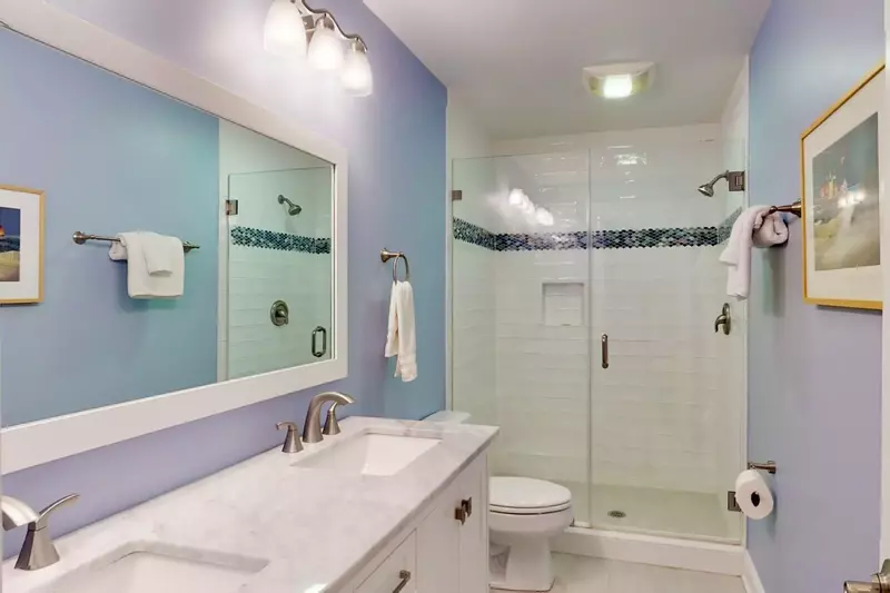 The hall bathroom has 2 sinks and a large walk in shower