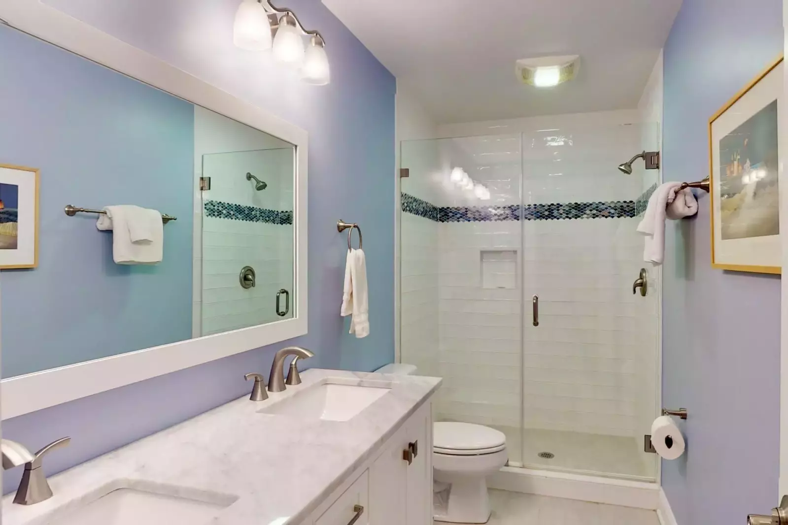 The hall bathroom has 2 sinks and a large walk in shower