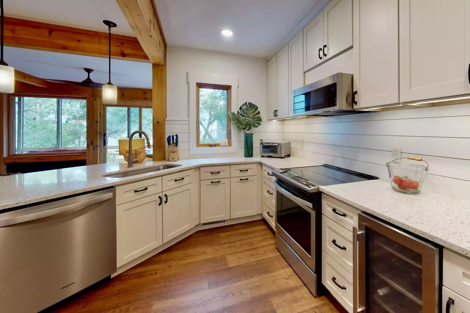 The kitchen has been redesigned and updated with new counters, appliances and cabinets